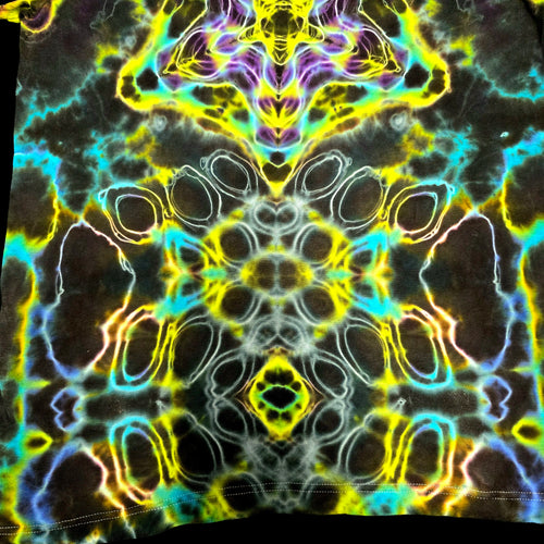 A close-up of a highly symmetrical, psychedelic tie-dye pattern featuring neon yellow, cyan, purple, and white abstract organic shapes.
