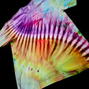 A short-sleeve crewneck tie-dye t-shirt with a vibrant spiral pattern of purple, pink, orange, yellow, and green, laid flat against a solid black background.