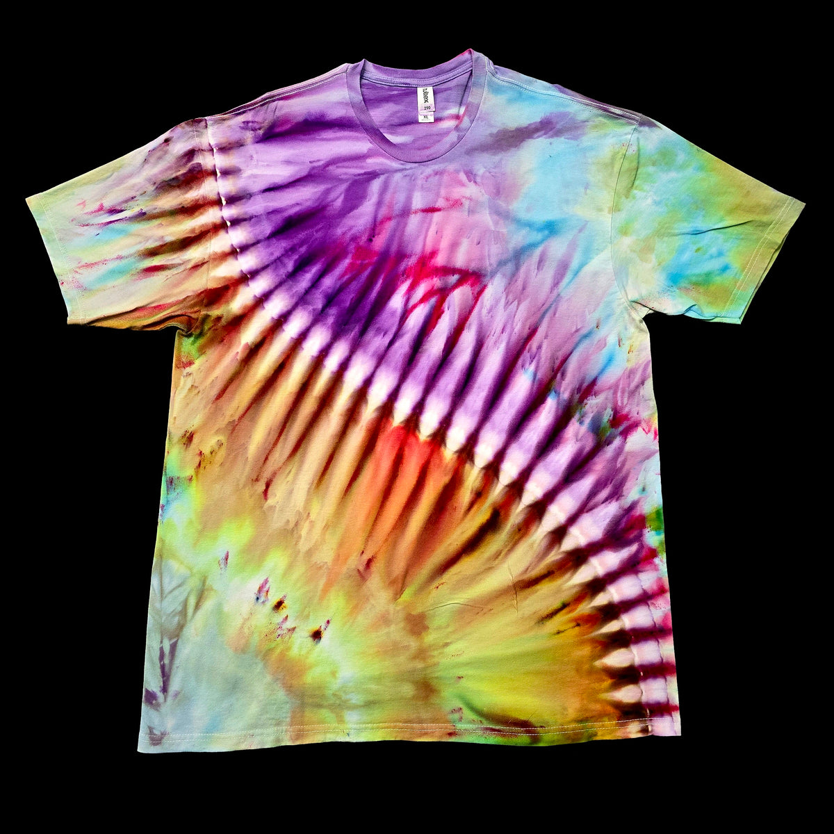 A short-sleeve crewneck tie-dye t-shirt featuring a radial burst pattern with purple, pink, yellow, green, and orange tones, displayed flat against a solid black background.