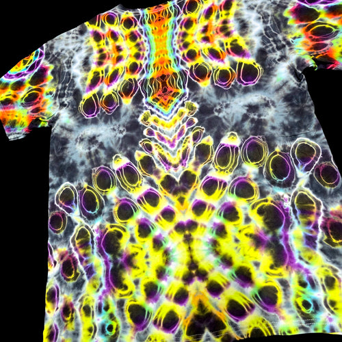 A short-sleeve crewneck t-shirt featuring a highly vibrant, psychedelic tie-dye pattern with neon yellow, purple, pink, and green outlines over a black and white marbled base, shown against a solid black background.