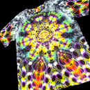 A short-sleeve crewneck t-shirt featuring a vibrant, multicolor psychedelic mandala print on a black base, shown against a solid black background.