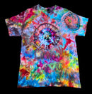 A short-sleeve crewneck tie-dye t-shirt featuring a large spiral pattern in the center and a smaller circular motif on the upper right chest, displayed flat against a solid black background.