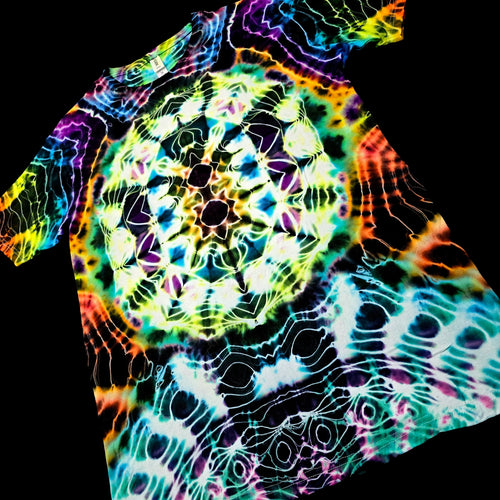 A short-sleeve t-shirt featuring a vibrant, psychedelic tie-dye pattern with a central mandala-like circular design and wavy rainbow lines over a black base.
