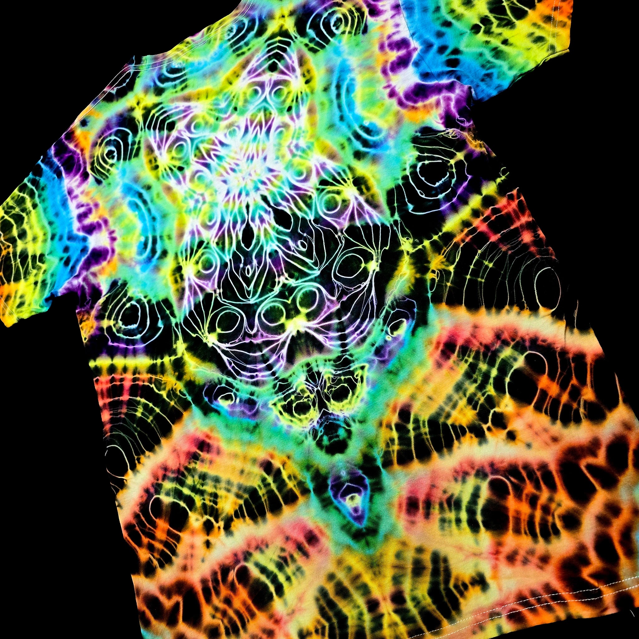 A short-sleeve t-shirt featuring a vibrant, psychedelic tie-dye pattern with neon rainbow colors over a black base.