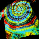 A short-sleeve tie-dye T-shirt laid flat on a black background, featuring a large spiral pattern with bright rainbow colors including blue, green, yellow, red, and purple.