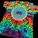 A short-sleeve tie-dye T-shirt laid flat on a black background, featuring a large spiral rainbow pattern with neon blue, green, yellow, orange, pink, purple, and black.