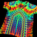 A short-sleeve tie-dye t-shirt with a psychedelic, high-contrast pattern featuring concentric arches and circular motifs in neon green, blue, purple, orange, yellow, and red, shown against a solid black background.