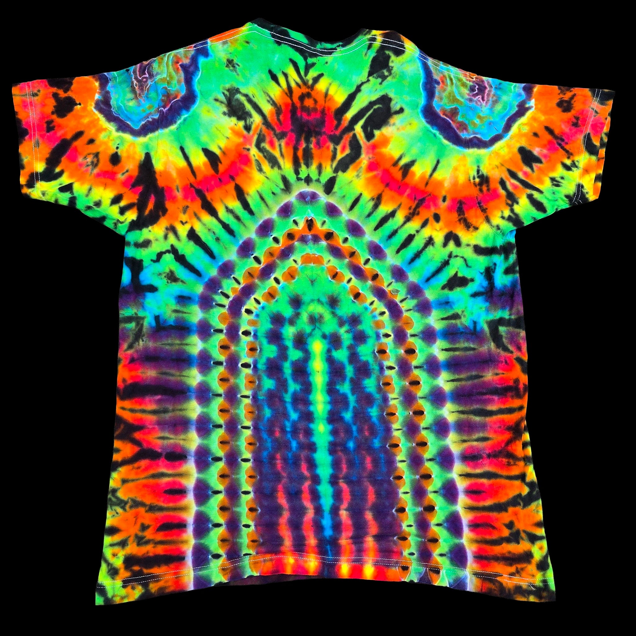 A short-sleeve tie-dye t-shirt with a highly symmetrical, neon rainbow pattern featuring concentric arches and circular motifs on a solid black background.