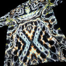 A short-sleeve t-shirt featuring a highly detailed, symmetrical psychedelic pattern with black, white, orange, and yellow organic shapes.