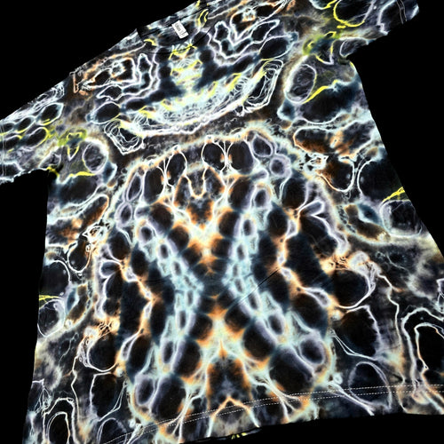 A short-sleeve t-shirt featuring a highly detailed, symmetrical psychedelic pattern with black, white, orange, and yellow organic shapes.