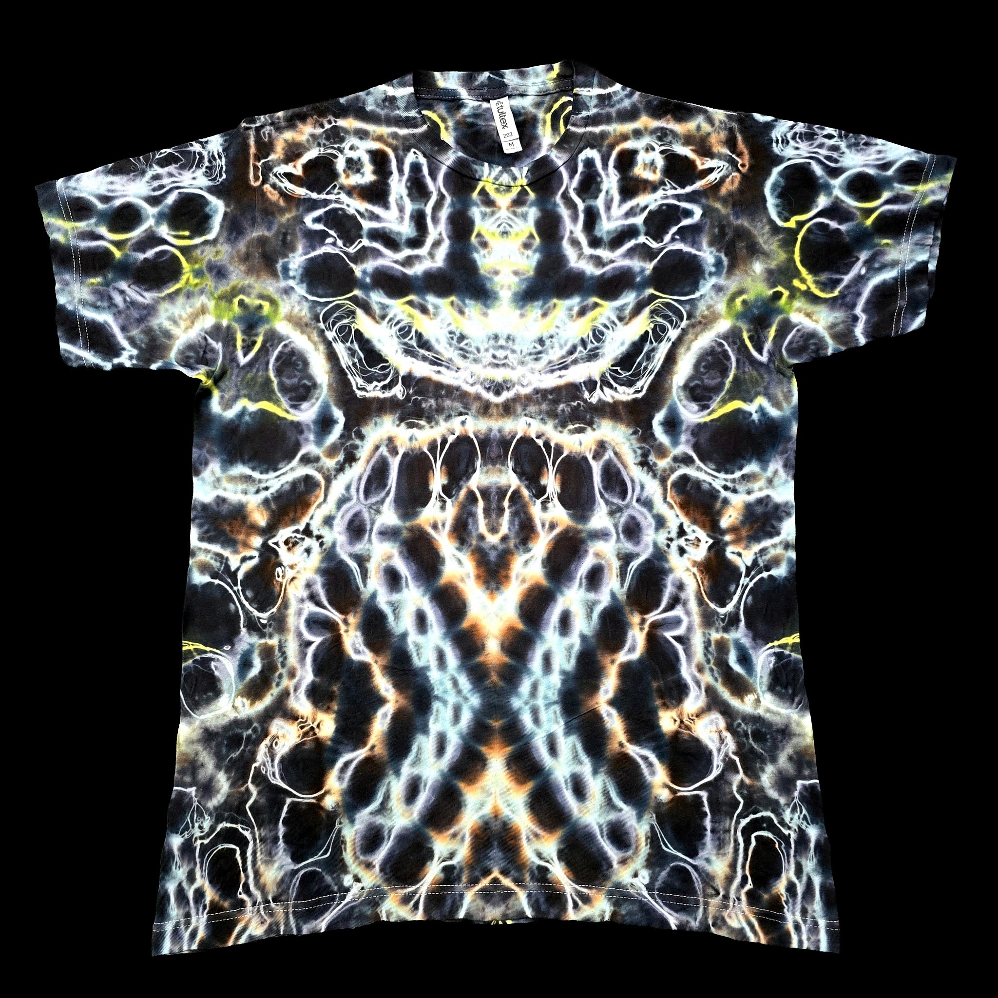 A short-sleeve crewneck t-shirt featuring a highly detailed, symmetrical psychedelic abstract pattern in black, white, yellow, and orange.