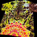 A short-sleeve crewneck t-shirt featuring a complex psychedelic tie-dye pattern. The top half displays a dark brown and bright yellow tie-dye motif, while the bottom half transitions into a vibrant, symmetrical mandala-like design with yellow, orange, red, and white concentric waves.