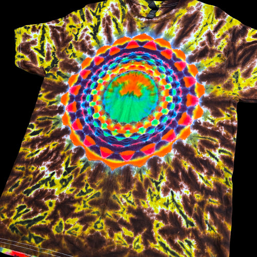 A short-sleeve crewneck t-shirt featuring a vibrant, psychedelic tie-dye pattern with a large concentric mandala design in the center. The pattern blends bright neon green, yellow, orange, red, and purple into a dark brown and black tie-dye spiral background.