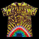 A short-sleeve tie-dye t-shirt laid flat against a solid black background. The shirt features a complex, symmetrical psychedelic pattern in yellow, brown, and black, with a vibrant rainbow arch pattern at the bottom hem.