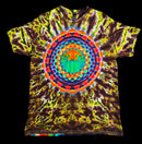 A short-sleeve crewneck t-shirt featuring a vibrant, multicolor tie-dye pattern with a large, symmetrical mandala design printed in the center. The base color is a mix of yellow, green, and dark brown, with the central mandala adding bright accents of orange, red, blue, and green.
