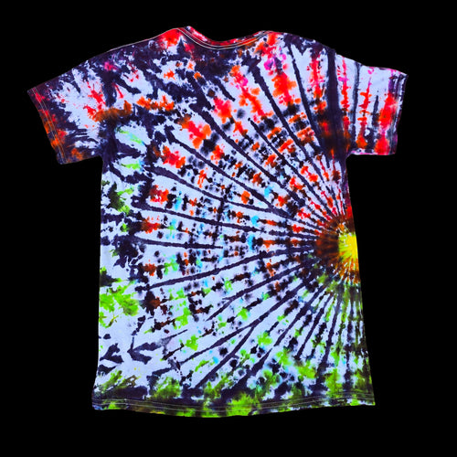 A short-sleeve tie-dye t-shirt with a vibrant radial burst pattern in red, orange, yellow, green, blue, and purple on a black background.