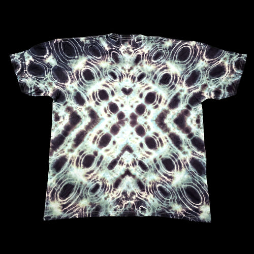A short-sleeve t-shirt with an all-over psychedelic tie-dye pattern of black, white, and pale green concentric circles, shown flat against a solid black background.