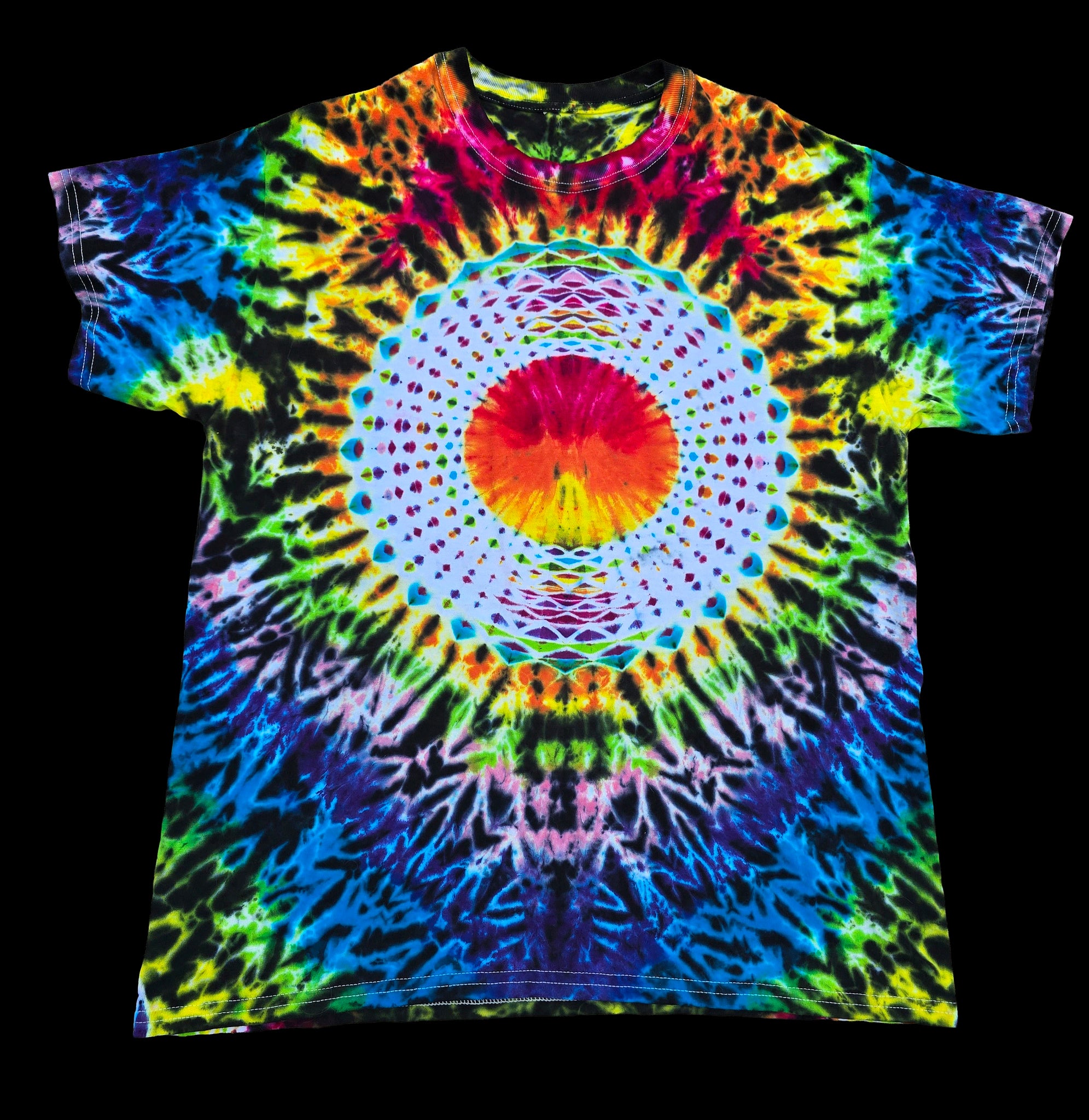 A short-sleeve tie-dye t-shirt featuring a vibrant, symmetrical mandala design with a central red and orange sun and radiating rainbow patterns on a black background.