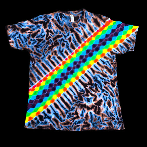 A short-sleeve crewneck t-shirt featuring a vibrant rainbow diagonal stripe pattern overlaid on a blue and brown tie-dye background, presented flat against a solid black background.