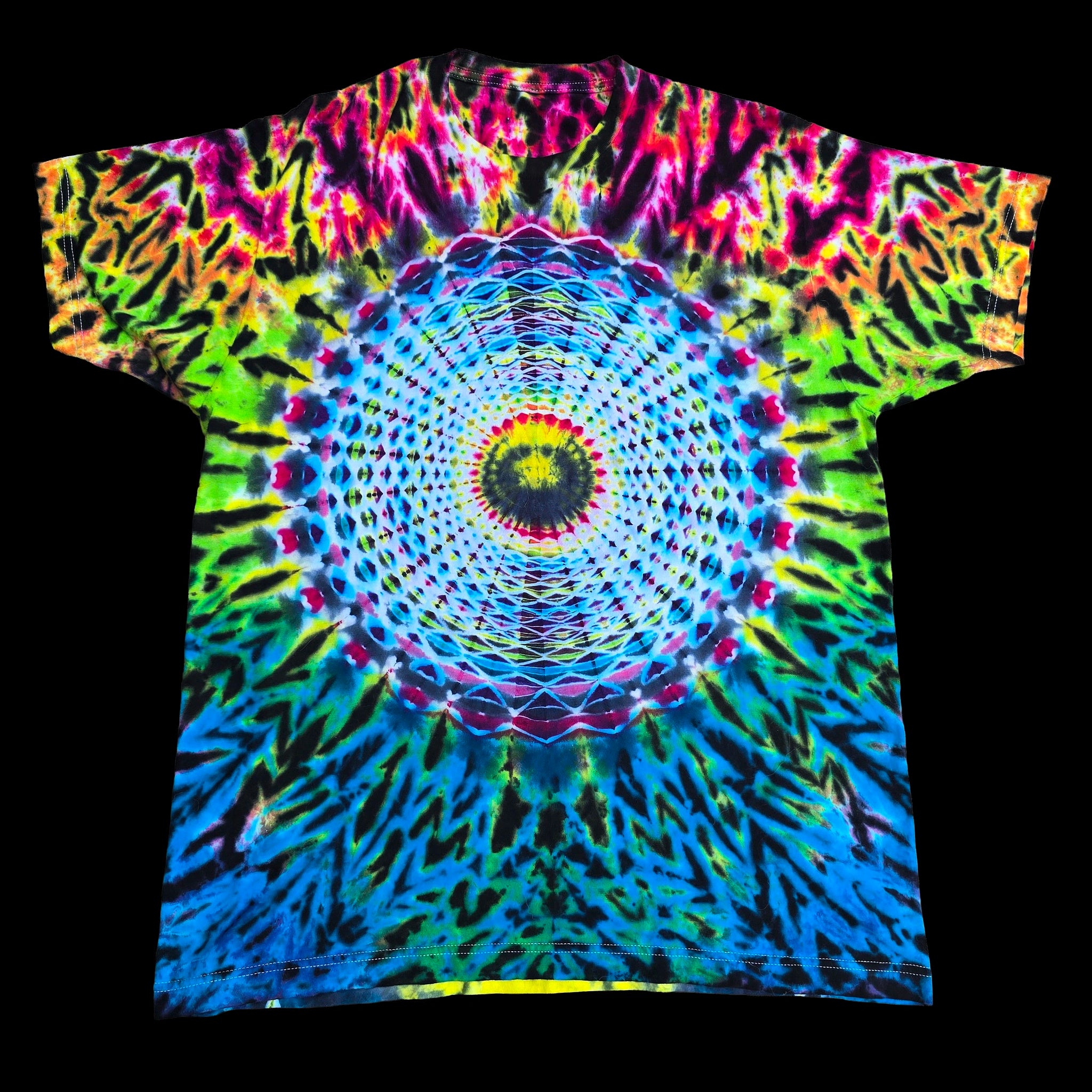 A short-sleeve crewneck tie-dye t-shirt featuring a vibrant, symmetrical mandala design in neon blue, green, pink, yellow, and purple, displayed flat against a solid black background.