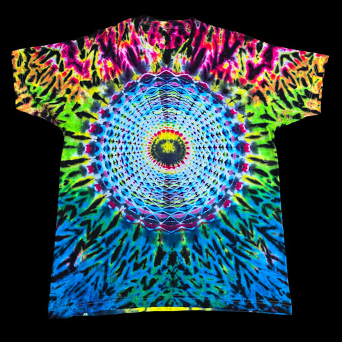 A short-sleeve crewneck tie-dye t-shirt featuring a vibrant, symmetrical mandala design in neon blue, green, pink, yellow, and purple, displayed flat against a solid black background.