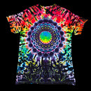 A short-sleeve crewneck tie-dye t-shirt featuring a large, intricate mandala design in the center. The shirt is covered in a vibrant rainbow tie-dye pattern with black tie-dye accents, shown against a solid black background.