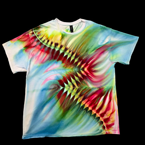 A short-sleeve crewneck t-shirt featuring a vibrant, multicolor tie-dye pattern with abstract, feather-like or butterfly-wing shapes in red, green, yellow, and blue over a white base, displayed flat against a solid black background.