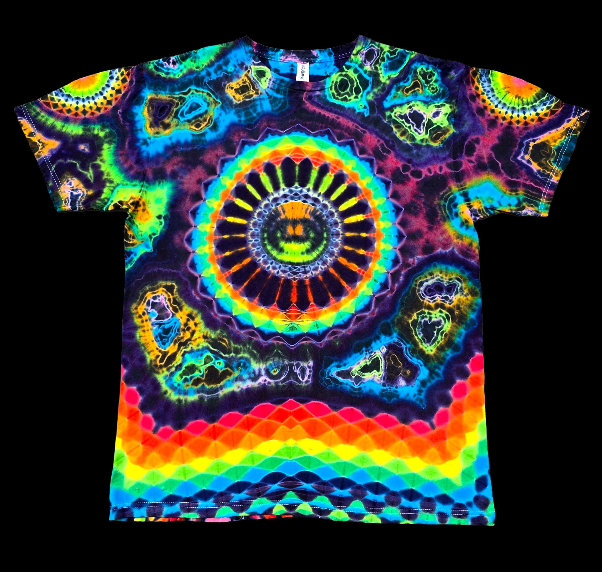 A short-sleeve crewneck t-shirt featuring a vibrant, symmetrical psychedelic mandala pattern with a rainbow spectrum of neon colors on a black background.