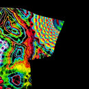 Macro detail of right sleeve showing yellow and blue geometric scale patterns on black cotton