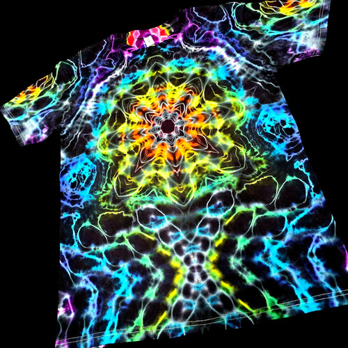 A short-sleeve crewneck t-shirt featuring a vibrant, neon psychedelic tie-dye mandala pattern on a black base, shown against a solid black background.
