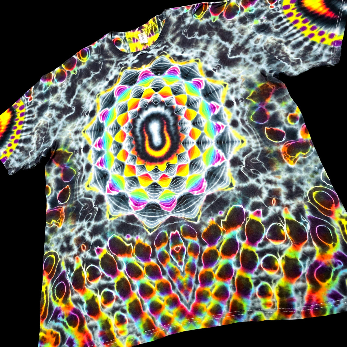 A short-sleeve crewneck t-shirt featuring a vibrant, psychedelic tie-dye pattern with a large central mandala design and an abstract organic pattern across the body and sleeves, shown against a solid black background.