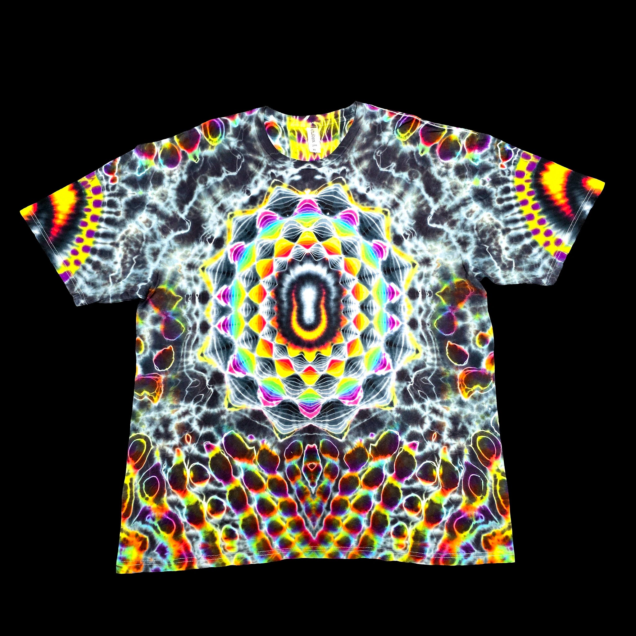 A short-sleeve crewneck t-shirt featuring a vibrant, symmetrical psychedelic mandala print with a central eye-like motif and neon rainbow colors on a black background.