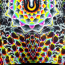 A close-up of a tie-dye fabric with a highly symmetrical, psychedelic pattern featuring neon rainbow colors on a black and white base.