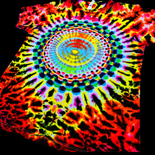 A short-sleeve tie-dye T-shirt with a large spiral mandala pattern in bright neon colors including red, orange, yellow, green, blue, purple, and black, shown against a black background.