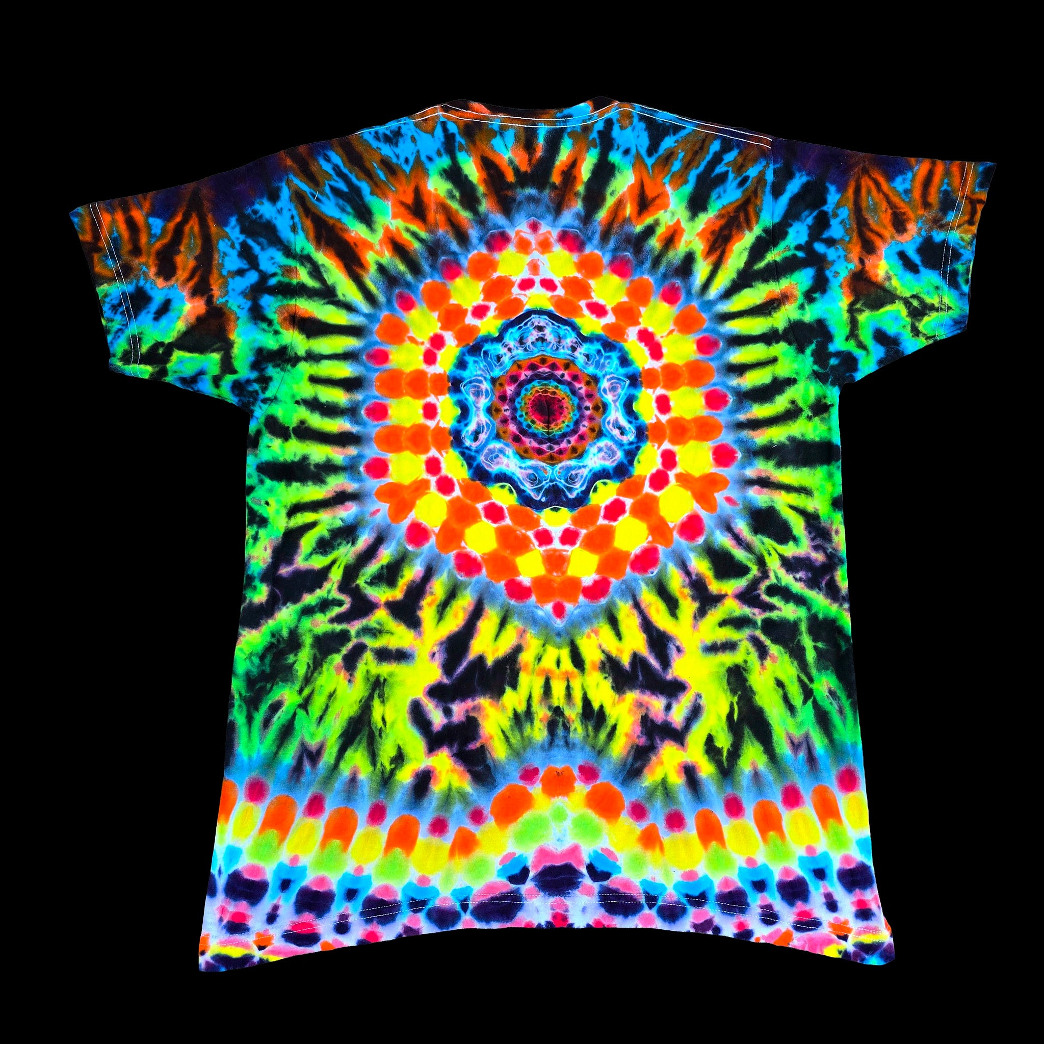 A short-sleeve crewneck t-shirt featuring a vibrant, multicolor tie-dye pattern with a central mandala and radial sunburst design, shown against a solid black background.