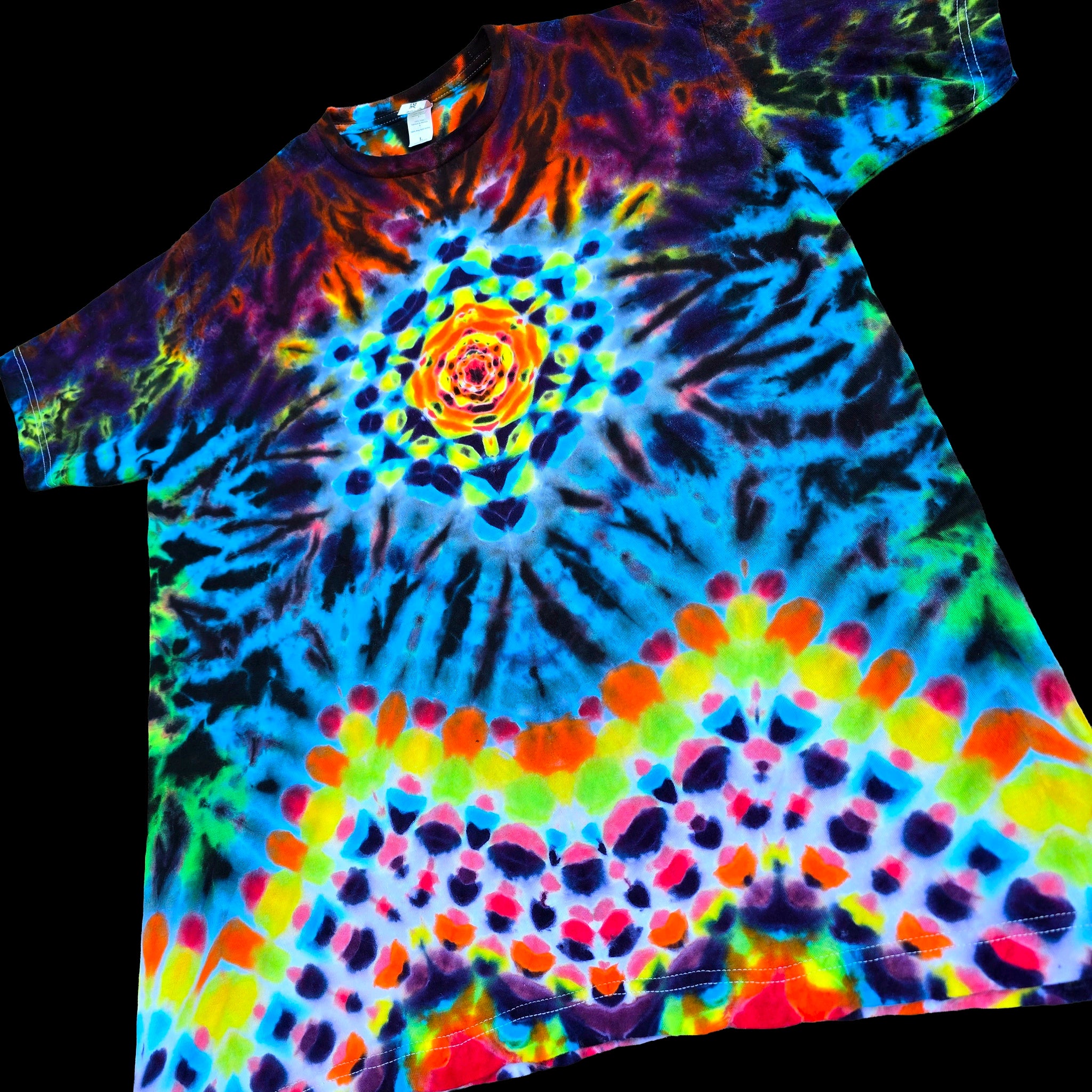 A short-sleeve tie-dye t-shirt featuring a vibrant spiral mandala pattern with neon blue, green, yellow, orange, and purple hues, displayed against a solid black background.
