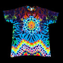 A short-sleeve crewneck t-shirt featuring a vibrant, symmetrical psychedelic tie-dye pattern with a central mandala design, displayed flat against a solid black background.