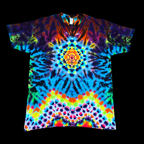 A short-sleeve crewneck t-shirt featuring a vibrant, symmetrical psychedelic tie-dye pattern with a central mandala design, displayed flat against a solid black background.