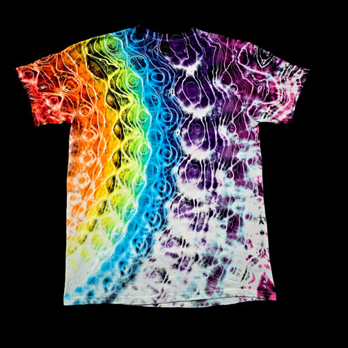A short-sleeve crewneck tie-dye t-shirt featuring a vibrant rainbow gradient transitioning into white and purple psychedelic swirl patterns, displayed flat against a solid black background.
