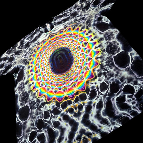 A black t-shirt featuring a highly detailed, colorful graphic print. The design displays a central kaleidoscopic mandala with rainbow-colored concentric rings and a dark blue center, surrounded by a white and black cellular or bone-like pattern.
