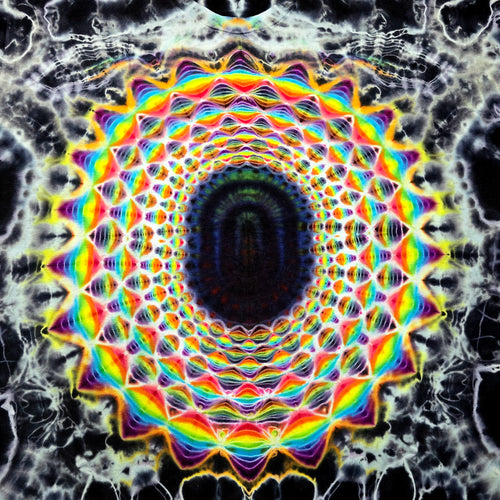 A highly symmetrical, psychedelic mandala pattern with concentric rings of rainbow colors including red, orange, yellow, green, blue, and purple on a black background with white web-like details.