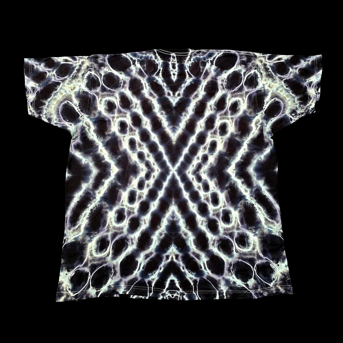 A short-sleeve t-shirt with an all-over abstract symmetrical pattern of glowing white and pale lavender circular and zigzag lines on a black background, shown flat against a solid black backdrop.