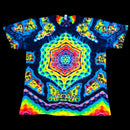 A short-sleeve crewneck t-shirt featuring a highly vibrant, psychedelic kaleidoscopic mandala pattern in neon yellow, green, blue, red, and purple on a black base, shown flat against a solid black background.