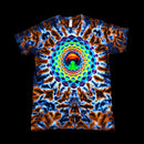 A short-sleeve crewneck t-shirt featuring a vibrant, symmetrical mandala design with a rainbow spiral pattern over a blue and orange tie-dye background.