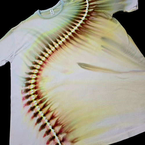 A white short-sleeve t-shirt with a tie-dye pattern featuring a curved line of yellow, green, and reddish-brown dye radiating across the front, laid flat against a black background.