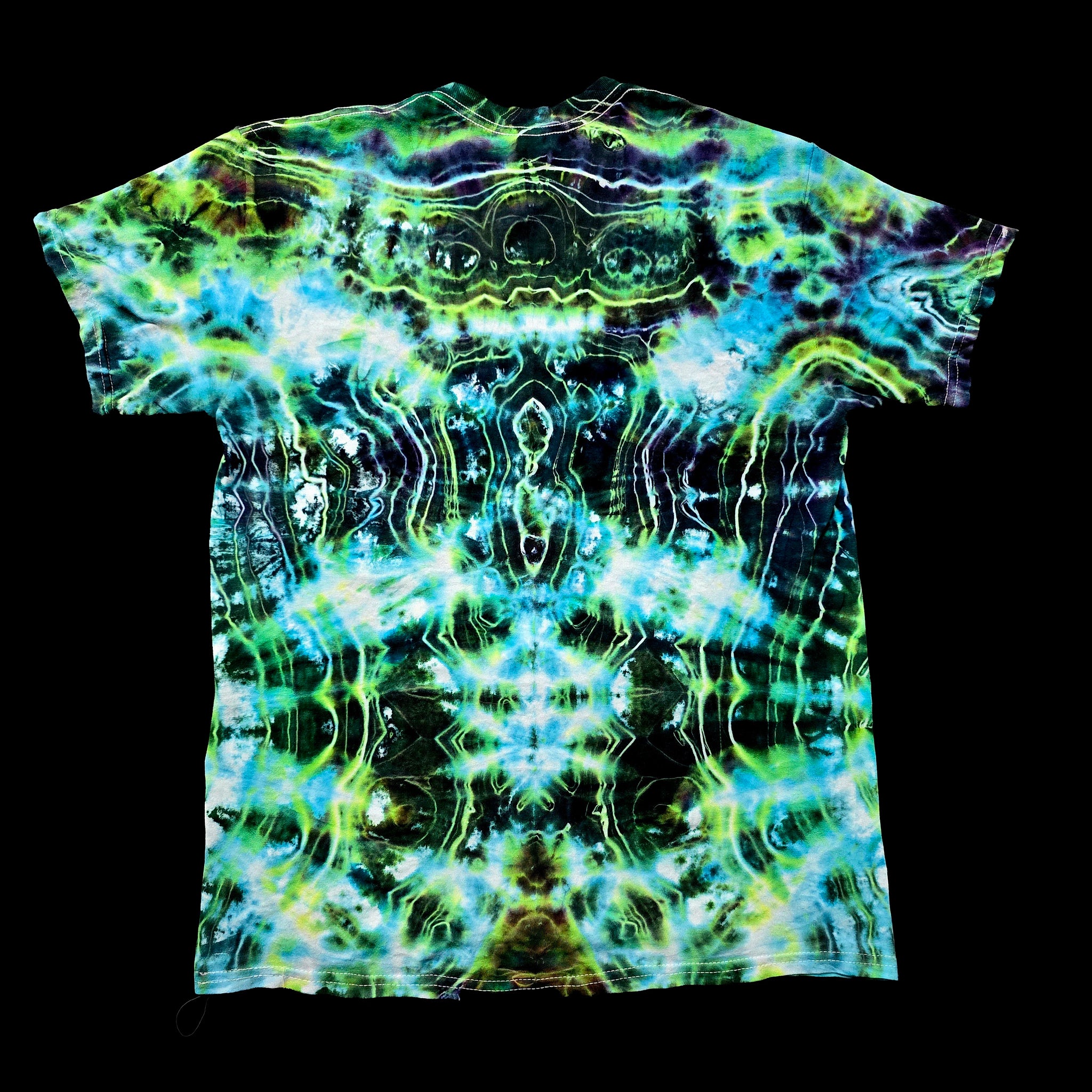 A short-sleeve crewneck t-shirt featuring a vibrant, symmetrical tie-dye pattern with neon green, blue, and black wavy lines, displayed flat against a solid black background.