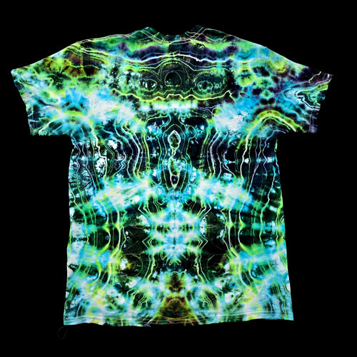 A short-sleeve crewneck t-shirt featuring a vibrant, symmetrical tie-dye pattern with neon green, blue, and black wavy lines, displayed flat against a solid black background.