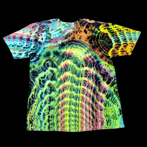 A short-sleeve crewneck t-shirt featuring a vibrant, multicolor psychedelic tie-dye pattern with concentric wave and spiral designs in neon green, yellow, orange, pink, and blue on a black background.