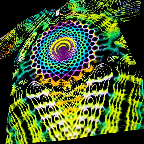 A black short-sleeve T-shirt with a highly vibrant, multicolor psychedelic spiral mandala print in neon green, yellow, purple, blue, and orange.
