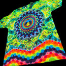 A short-sleeve tie-dye T-shirt laid flat on a black background, featuring a psychedelic mandala and eye pattern with rainbow stripes along the bottom hem.